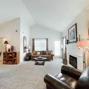 Living room with couch and table, ceiling fan and lights