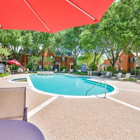 Outdoor swimming pool with a red umbrella