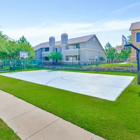 Basketball court with grassy lawn