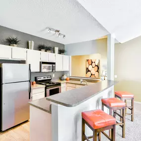 Interior kitchen with bar style counter tops and seating