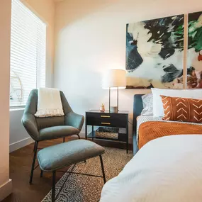 Bedroom with a bed and a comfortable chair