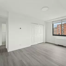 A Spacious Room With a Window Overlooking a Building