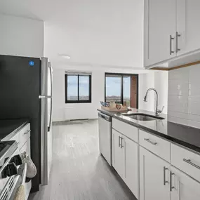 A Modern Kitchen With Black Stove Top