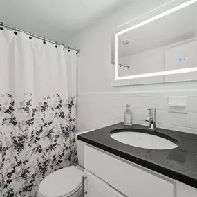 A Bathroom With a Floral Shower Curtain