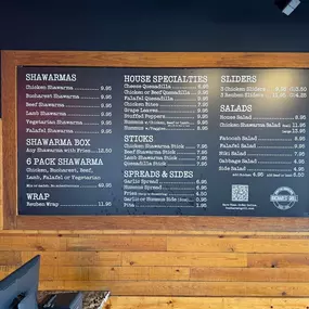 Menu board displaying shawarma and Mediterranean options at Bucharest Grill Detroit