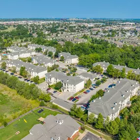Bird's eye view of a residential area with houses and parked cars