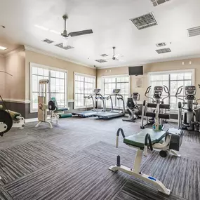 Spacious gym with a variety of equipment including treadmills, exercise bikes, and weight machines