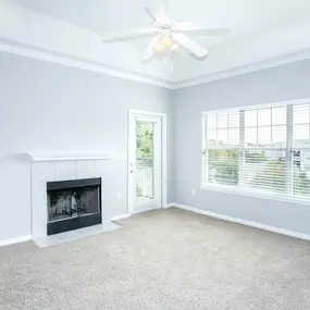 Living room with a fireplace and a ceiling fan