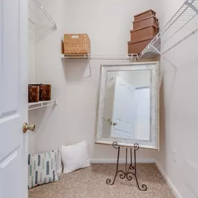 White closet with a mirror and shelves