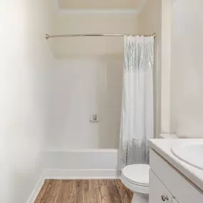 White bathroom with a tub and vanity