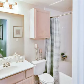 Bathroom with pink cabinets
