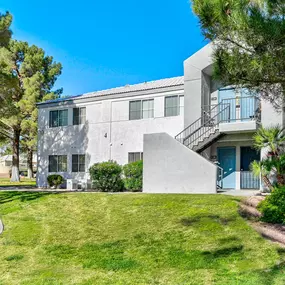 Exterior of apartment with trees and lush landscaping