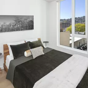 a bedroom with a bed and a large window