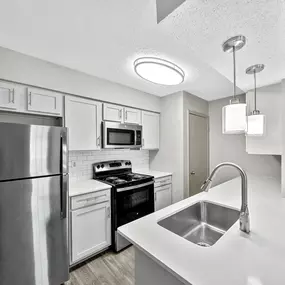 Kitchen with white cabinets and stainless steel appliances