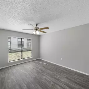 Room with ceiling fan and oversized window