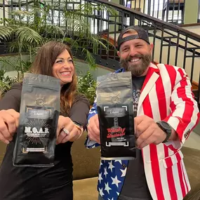 2 people holding bags of coffee