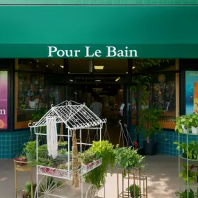 Pour Le Bain boutique in Uptown Whittier welcomes guests with a lush storefront display of indoor and outdoor plants. Beneath the signature green canopy, the shop invites you into a curated world of skincare, bath essentials, jewelry, and botanical gifts.