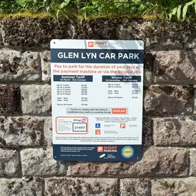 A detailed look at the Glen Lyn Car Park tariff board, outlining summer and winter parking charges, RingGo app code, and terms. Positioned beside the InstaVolt EV chargers for driver convenience.