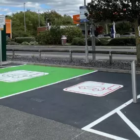 InstaVolt EV charging bays near a Sainsbury’s, featuring clearly marked spaces and dual chargers.