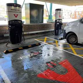 Covered InstaVolt charging station with dedicated EV bays, featuring clear markings and easy access for drivers.