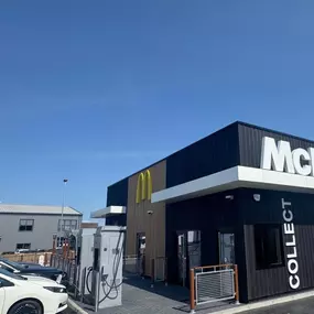 Side view of a McDonald’s drive-thru with InstaVolt chargers and parked electric cars in front.