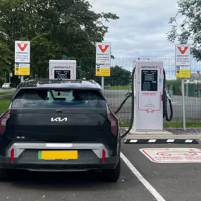 This photo shows multiple vehicles using InstaVolt’s ultra-rapid EV chargers at a clean and well-marked charging bay. The site includes visible signage, safety markings, and a branded support van, reflecting a professional and user-friendly environment for electric vehicle drivers.