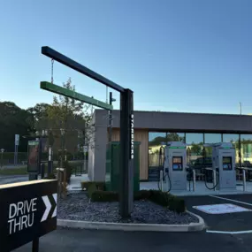 The InstaVolt charging station sits beside a modern Starbucks with drive-thru access, providing a quick charge and coffee stop for EV drivers.
