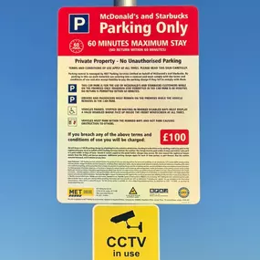 A clear sign details parking terms for customers at McDonald’s and Starbucks, including a 60-minute maximum stay and CCTV monitoring.
