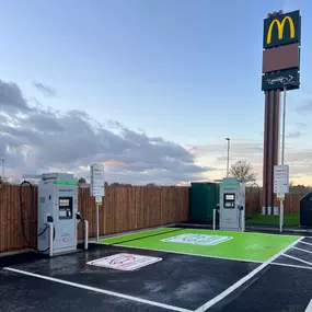 Two InstaVolt EV chargers at McDonald’s Fairhill, Bedford, shown with clear EV bay markings and the iconic McDonald’s drive-thru sign in view.