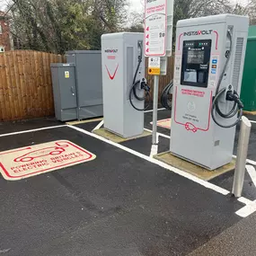 Two InstaVolt ultra rapid chargers at Bristol Golf Centre, featuring clearly marked parking bays for electric vehicles, secure bollards, and visible site signage.