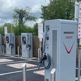Multiple InstaVolt ultra rapid EV chargers with signage at Bristol Golf Centre