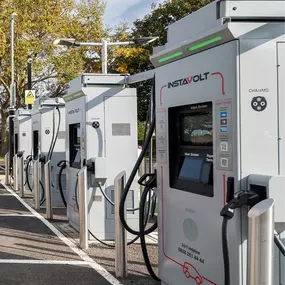 A row of InstaVolt ultra-rapid electric vehicle chargers located in Skegness. Surrounded by trees, this clean and well-marked charging area is designed for easy access and fast charging.