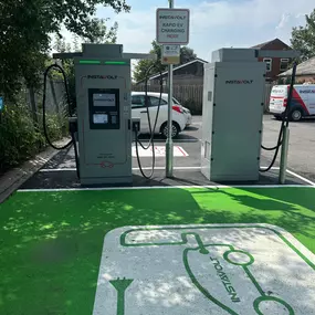 This InstaVolt charging site in Coppull features ultra rapid EV chargers with user-friendly touchscreens, card payment options and signage indicating charging availability.