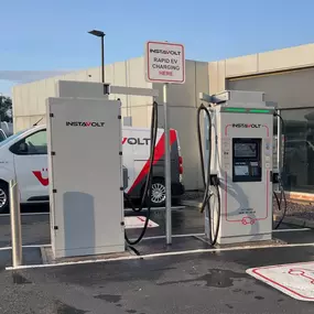 Dual InstaVolt rapid chargers are installed in a clean, accessible car park in McDonald's Middlesbrough, supported by clear signage and visible branding on service vehicles.