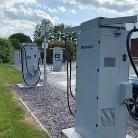 This image shows multiple InstaVolt ultra rapid electric vehicle chargers installed at Cobbs Farm Shop on the A4 Bath Road. The clean setup and clear signage make it easy for drivers to identify charging bays, surrounded by greenery for a pleasant stop.