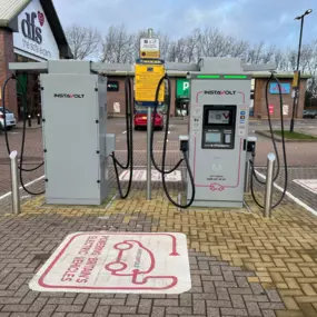 Two InstaVolt chargers are positioned outside a DFS store, offering EV charging close to shops and parking facilities.