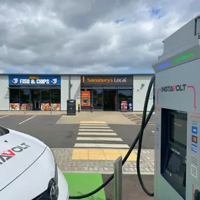 InstaVolt charger located directly outside Sainsbury’s Local and Rumbles Fish & Chips, offering easy access to food and essentials while you charge.