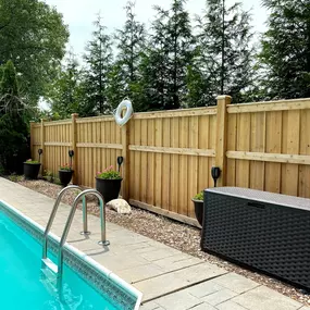 wood fence in a backyard with a pool