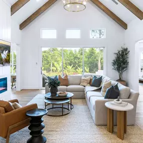 Large great room with soaring high ceilings and ample natural light