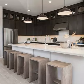 Well-designed kitchens with large center island, breakfast bar, and sizable pantry