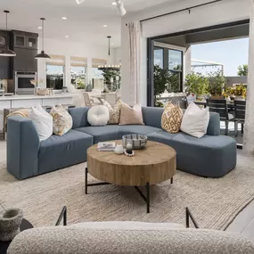 Open-concept floor plans with views of the kitchen, dining area, and rear covered patio beyond