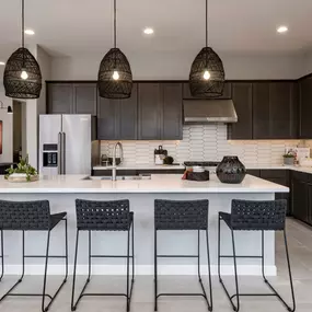 Luxurious kitchens with large center islands, ample countertop, and cabinet space