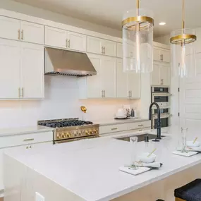 Gourmet kitchen is highlighted by a large center island and double-stacked cabinets for ample storage space