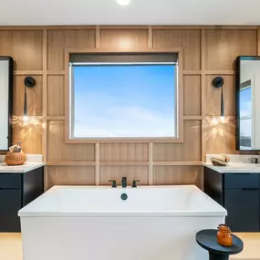 Luxe 5-piece bathroom with separate vanities and a free-standing tub