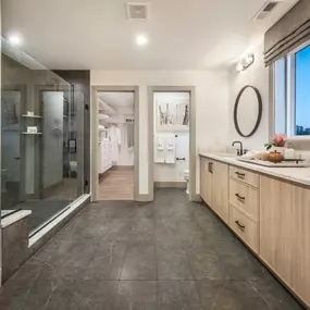 Spa-like primary bathroom with dual-sink vanity and enclosed shower