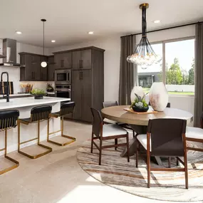 Beautiful kitchen with upgraded cabinets, cozy dining area, and island