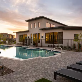 Community pool area with ample lounge chairs
