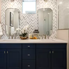 Primary bathroom with striking accent wall and glass shower door