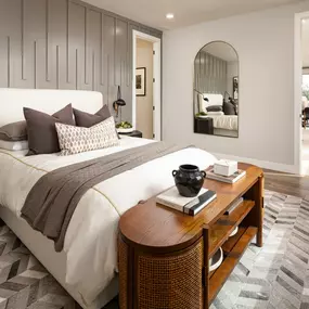 Primary bathroom suite with patterned tile and dual-sink vanity
