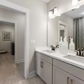 Spacious secondary bathrooms with dual-vanities and walk-in shower